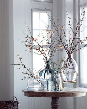 Jarrones decorativos con coloridas ramas de flores secas y ramas